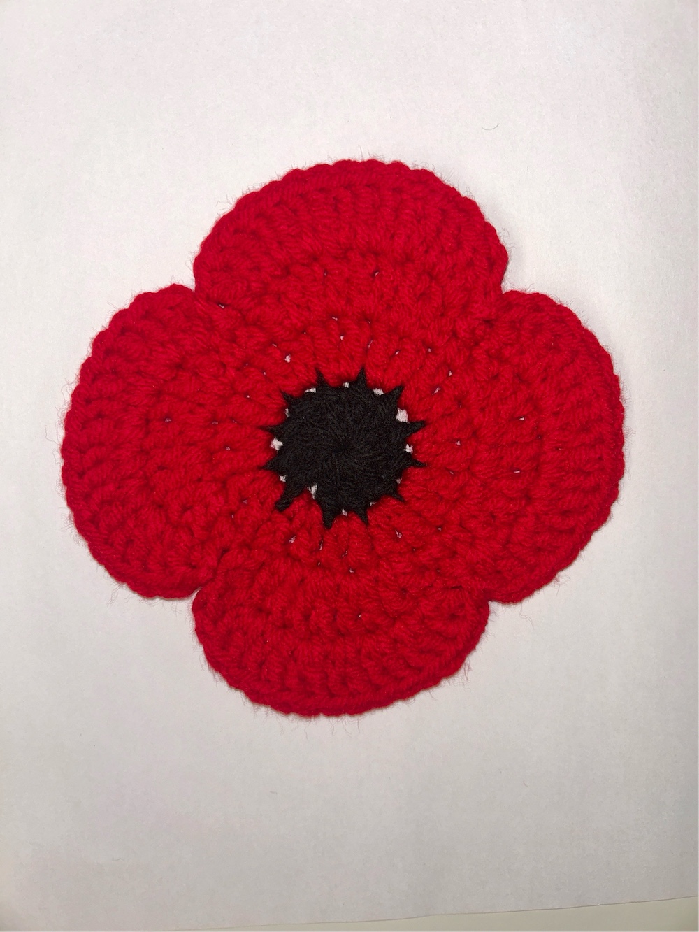 Crocheted Poppy on white background