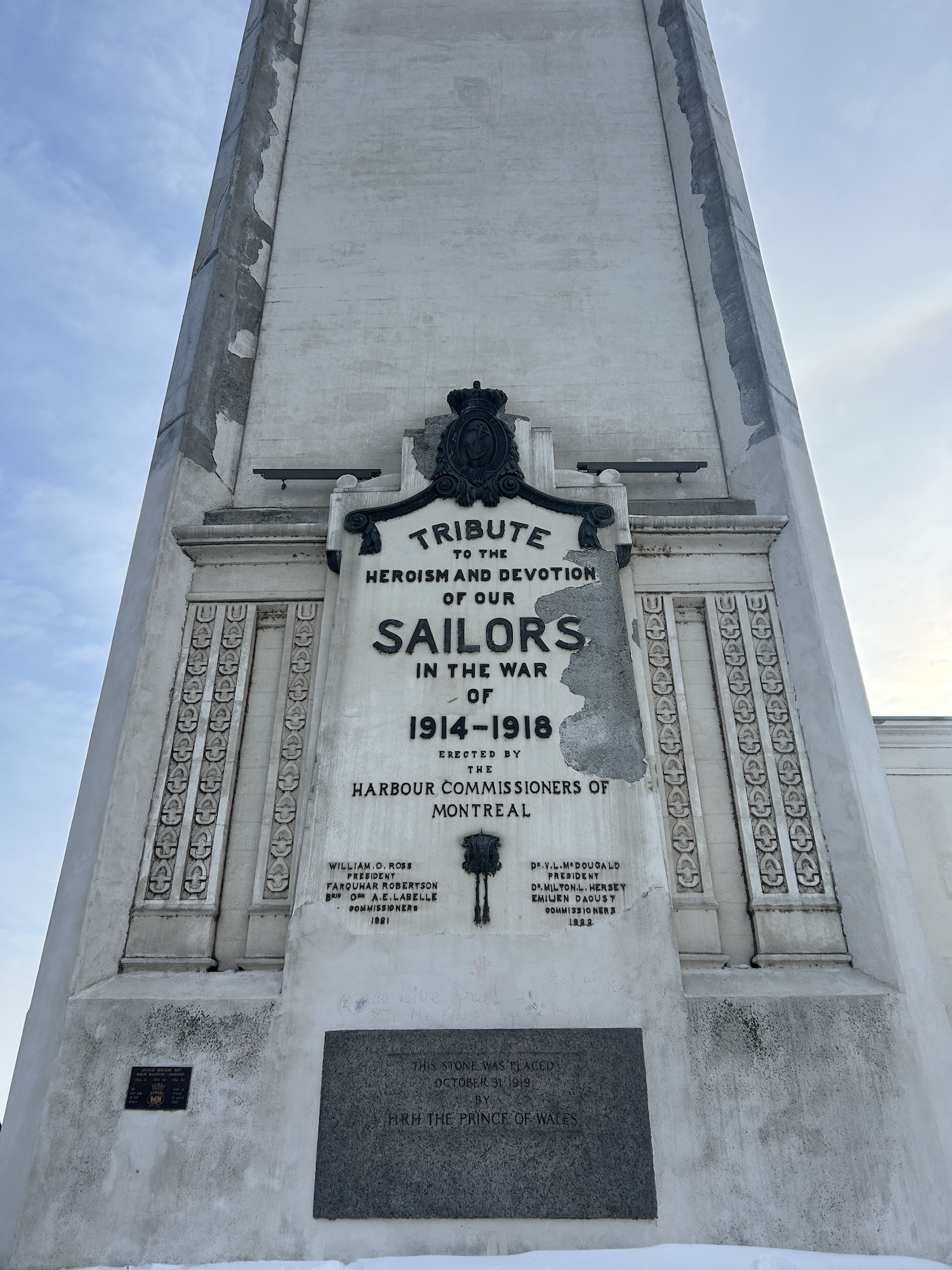 Close up of a tower’s plaque, honoring “the heroism and devotion” of			members that served the First World War. A grey panel below reads, This stone was		placed October 31st 1919 by H.R.H The Prince of Wales